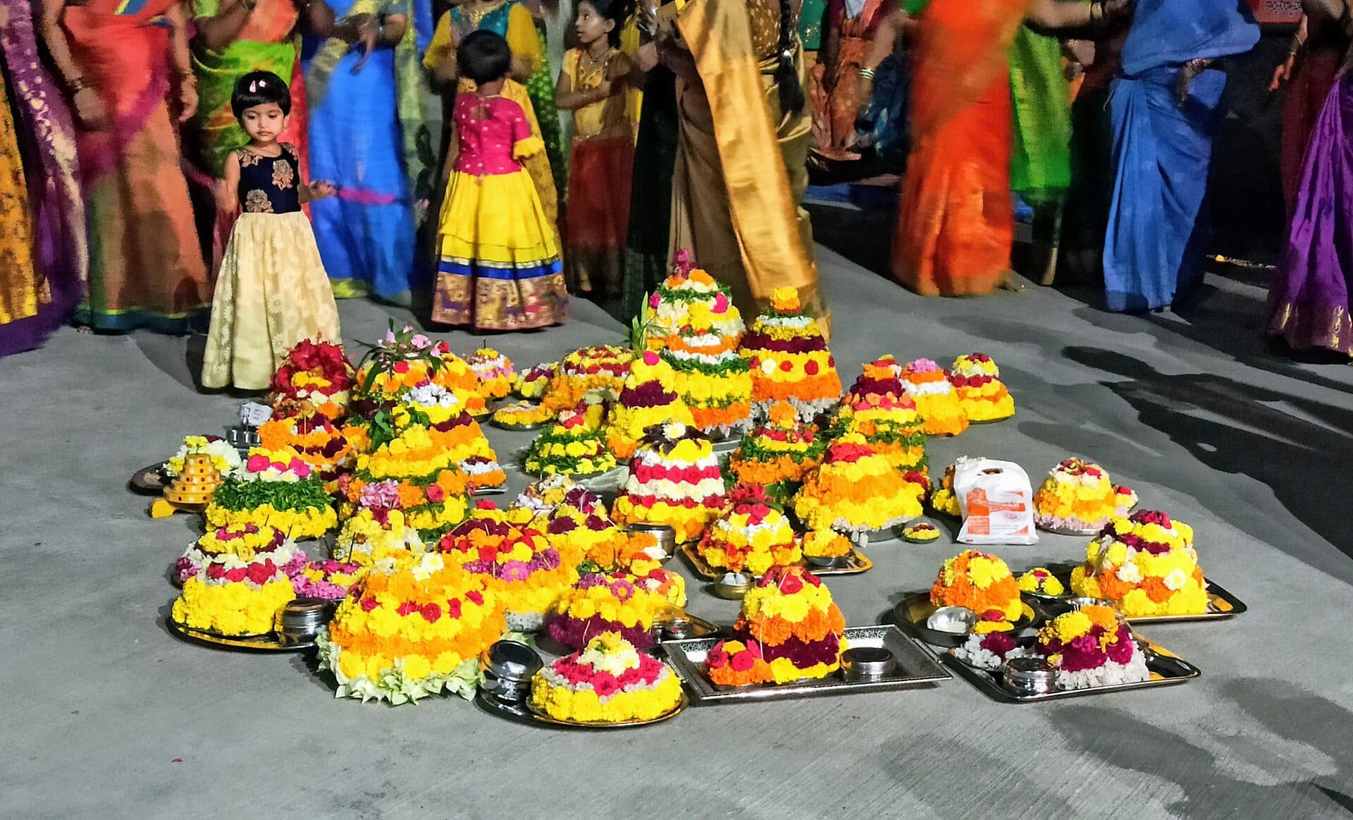 Colourful Bathukamma flower stacks arranged for the festival