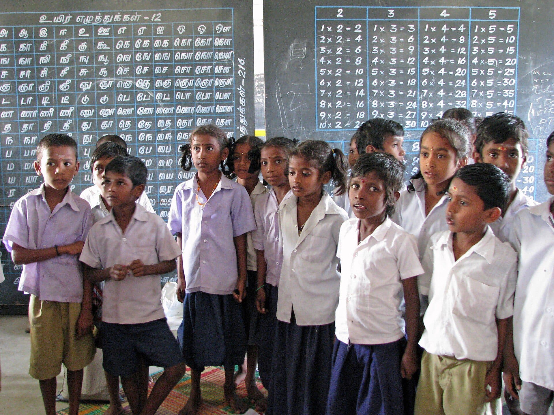 Students in school uniform standing in their classroom