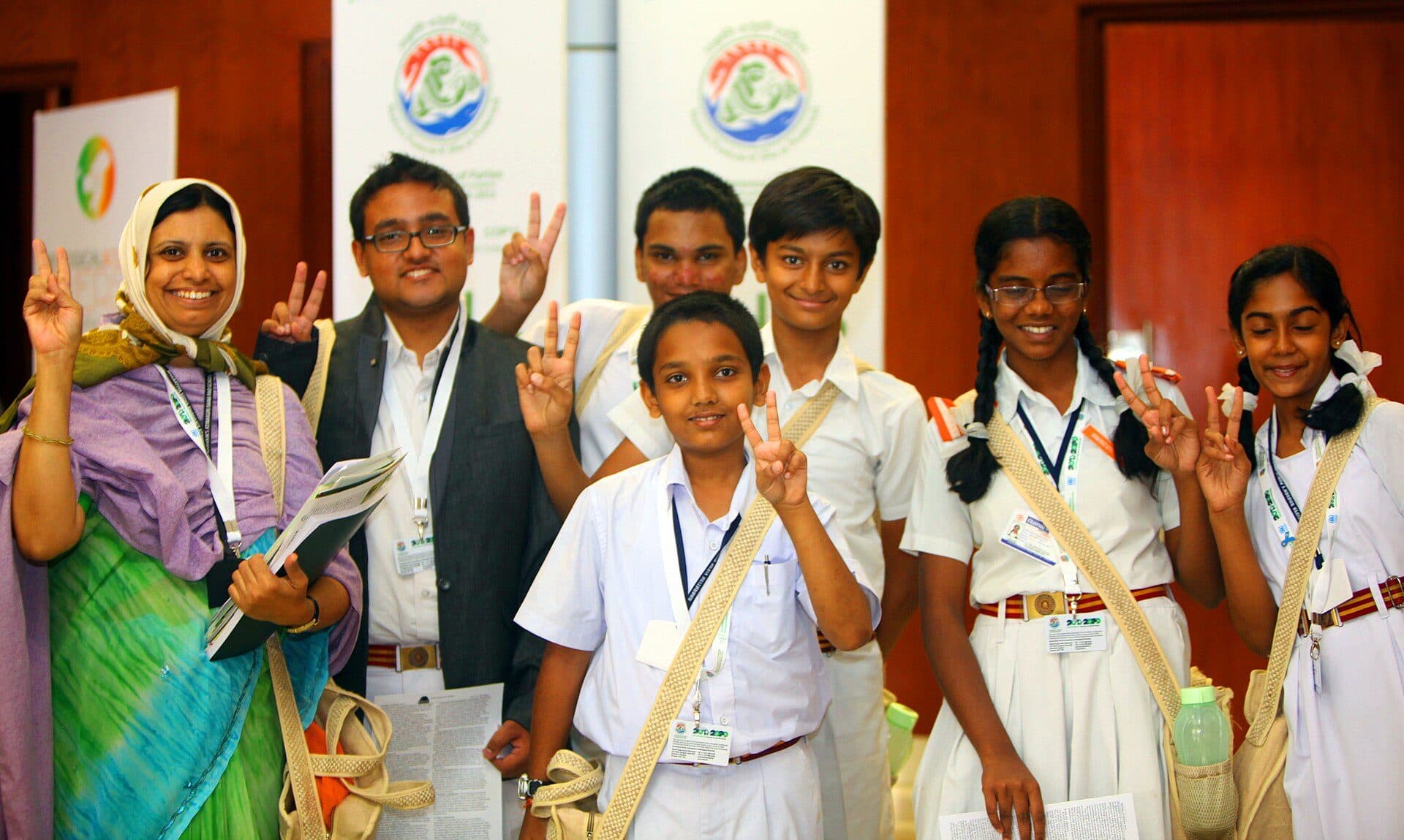 Hyderabad students in uniform with their teacher at an event