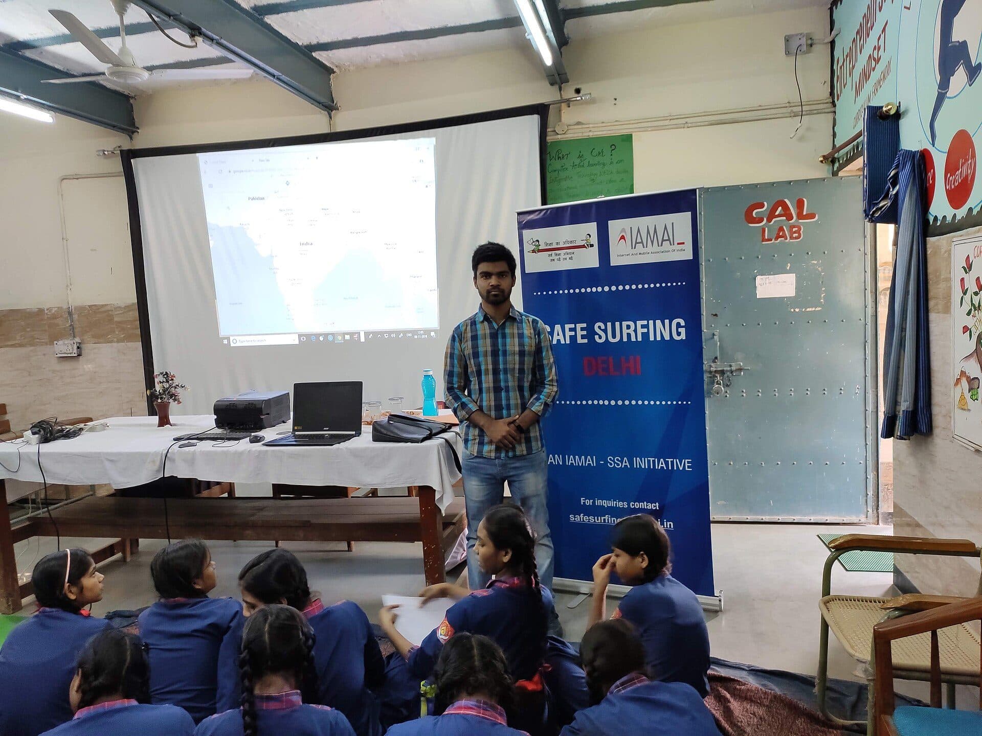 A mentor speaking to a room of schoolchildren