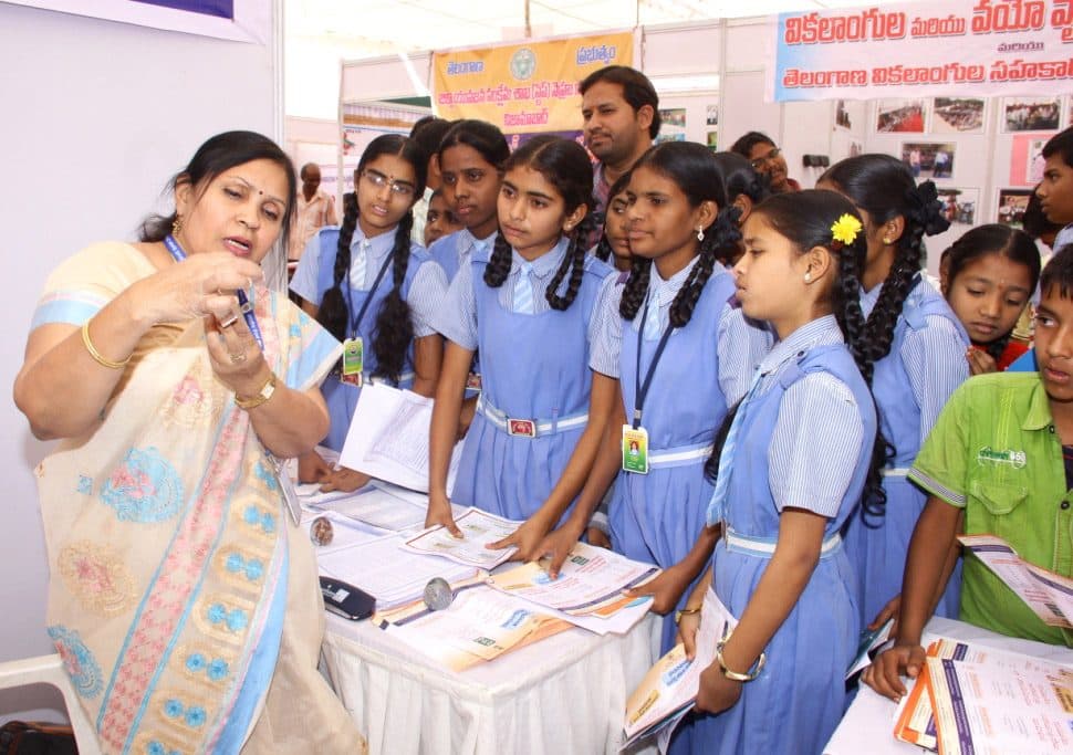 Schoolgirls in blue uniforms at a public information campaign in Armoor