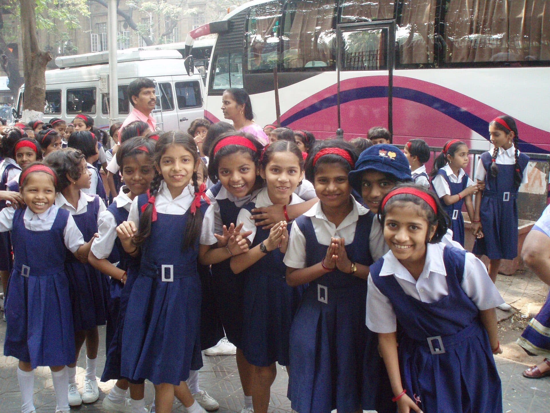 Schoolgirls in blue uniforms smiling together